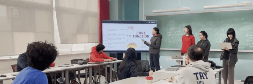 Picture of one of the student groups discussing their coding in the oral defense